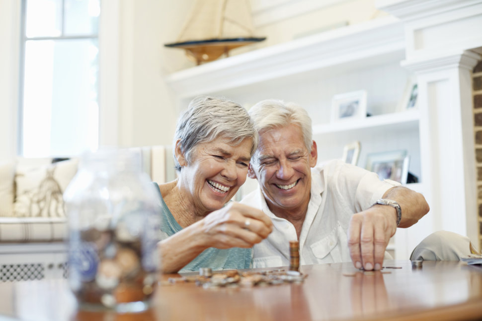 old couple happily counting savings